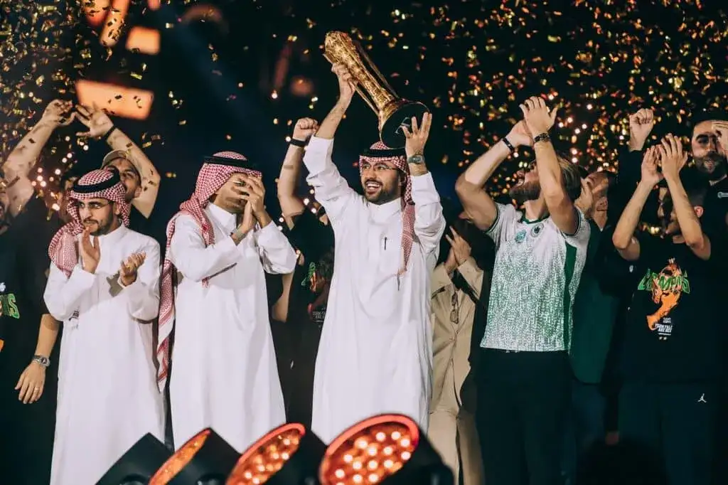 Winners celebrate on stage during a major esports tournament trophy ceremony in Saudi Arabia